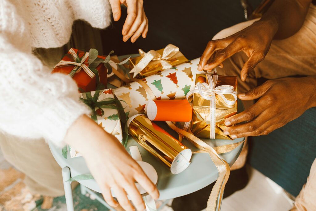 Hands preparing Christmas gifts with colorful ribbons and wrap.find the perfect gift for every occasion